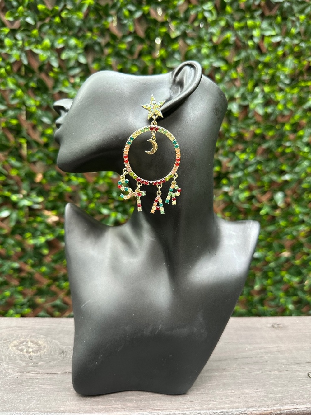 Multi-colored star and moon earrings with the word 'STAR' in colorful letters